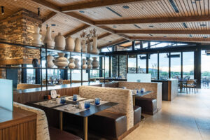 An interior shot of the benches inside the Renegade Clubhouse dining room at Desert Mountain adorned with pottery, anchoring a top destination for golf in Scottsdale, Arizona