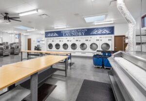 Image showing multiple washers and dryers at the receiving, laundry and recycling facility at Desert Mountain Club
