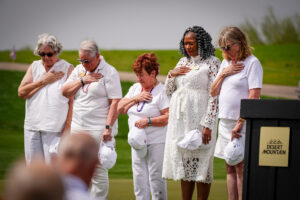 families of veterans with their hand over their heart at tee it up for the troops at desert mountain club