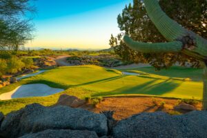 a green at cochise golf course with cactus in foreground