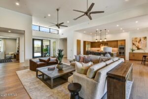 a mid sized home at desert mountain club with white walls and ceilings and a large open living space and kitchen