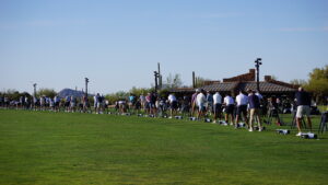 shot of golfers practicing on a driving range before mountain mania, one of the many golf winter season golf events at desert mountain