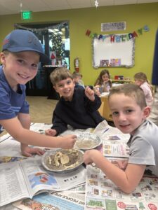three kids doing one of the many activities for kids at desert mountain club inside the youth center