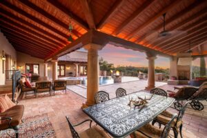 spacious scottsdale backyard design patio with wooden coverings lit up at night