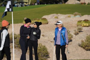 ladies on a golf green at desert mountain club smiling and laughing