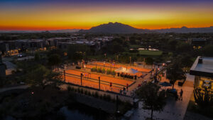 high and wide shot at sunset showing the new bocce ball court setup at seven desert mountain at desert mountain club with a mountain silohuette in the background